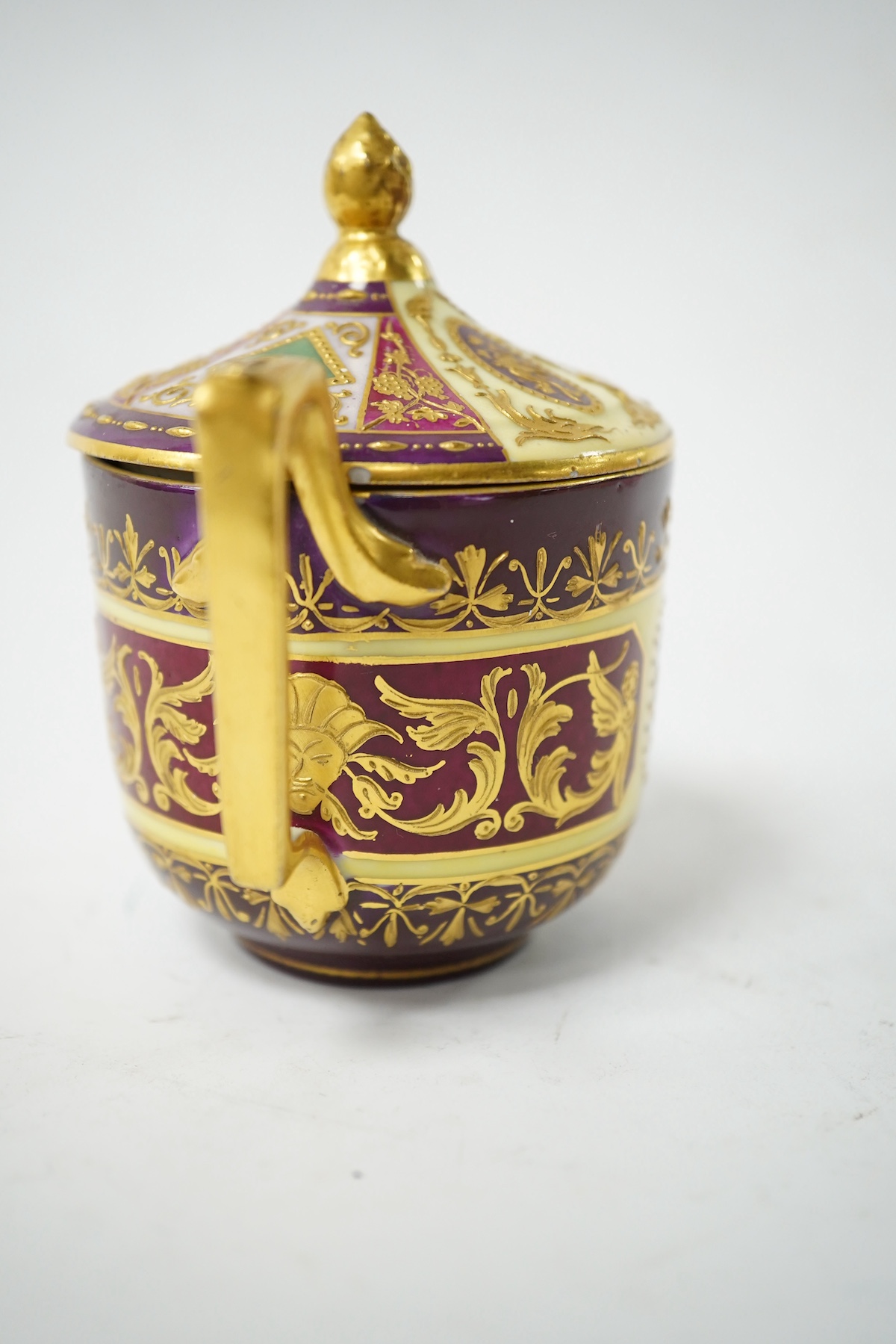 A late 19th century Vienna custard cup and saucer, outside and later decorated, beehive mark, 10cm high. Condition - good